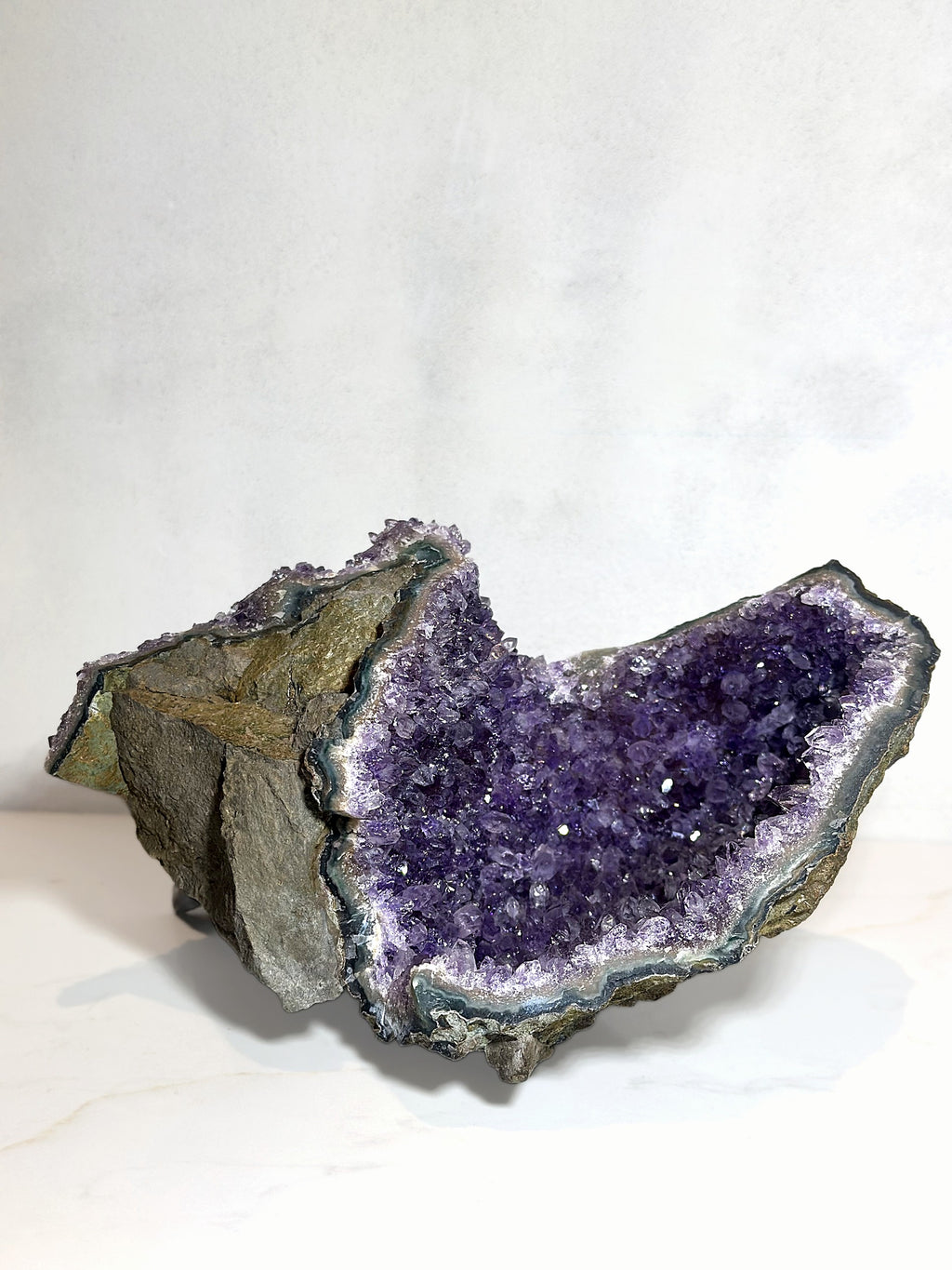 Amethyst cluster laid on its side, showing the depth of the crystal cave