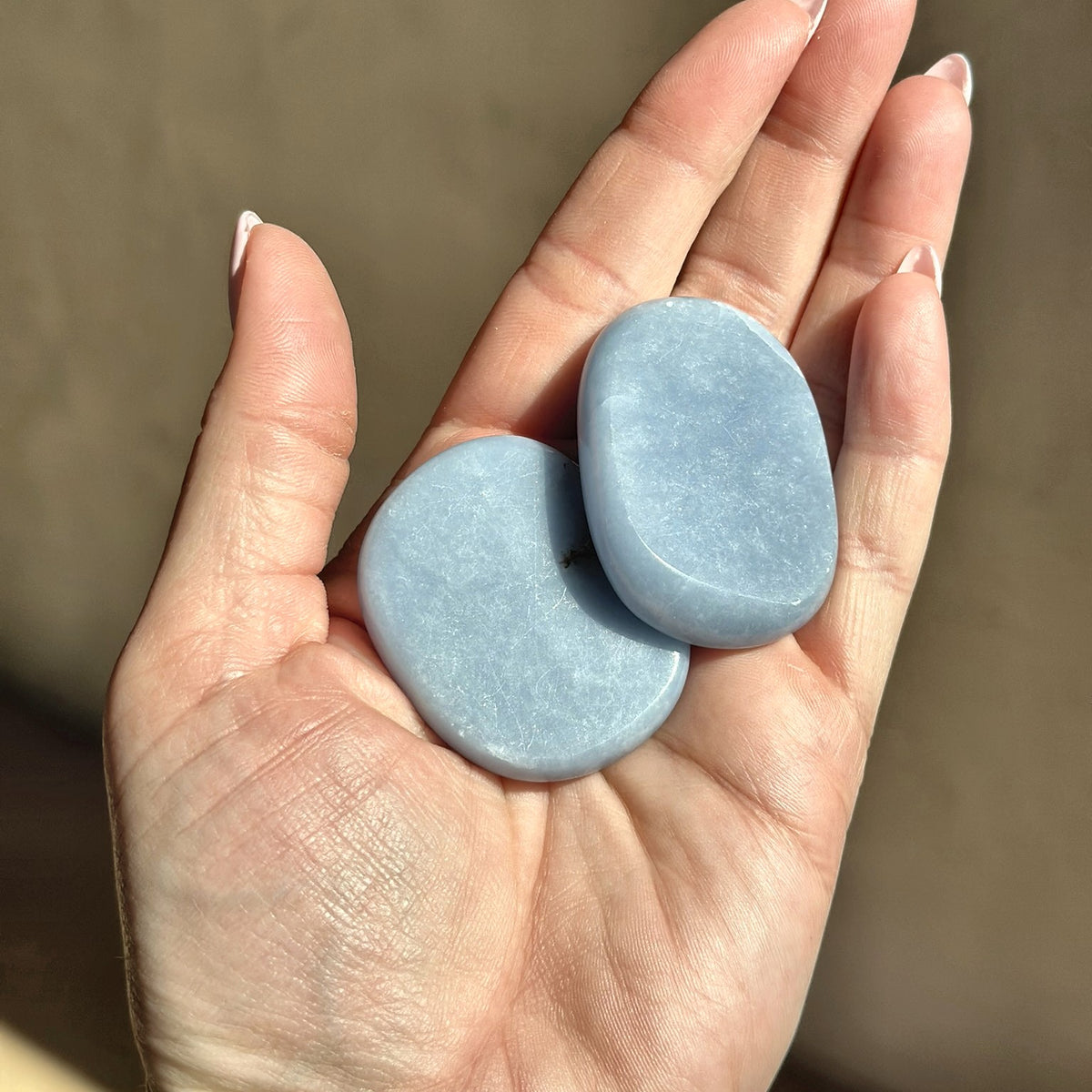 Smooth meditation stone of soft blue angelite, second view