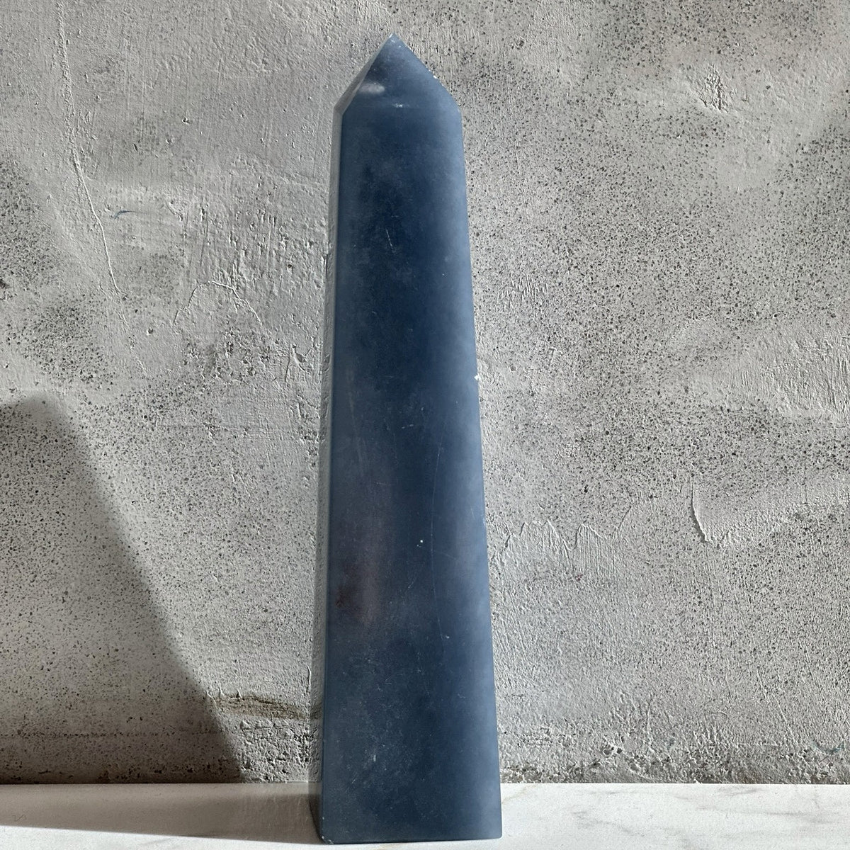 Polished point of soft blue angelite