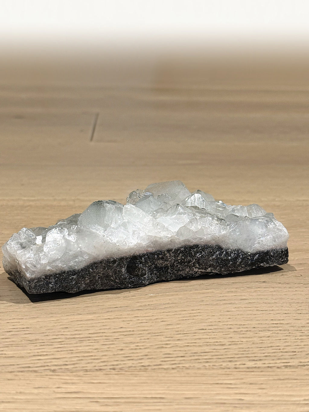 Clear apophyllite crystals on a dark basalt base