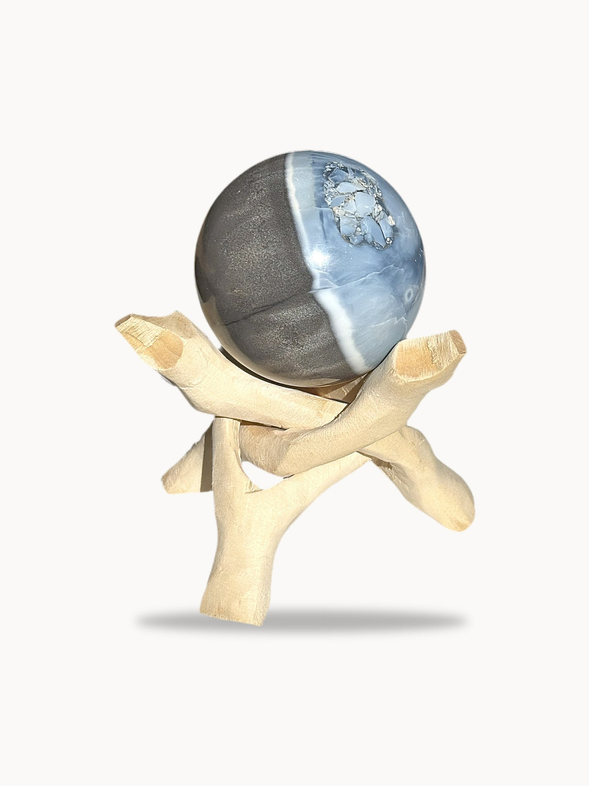 Large blue opal sphere, sky blue and smoky gray, side view