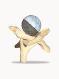 Small pale blue opal sphere on a wooden stand