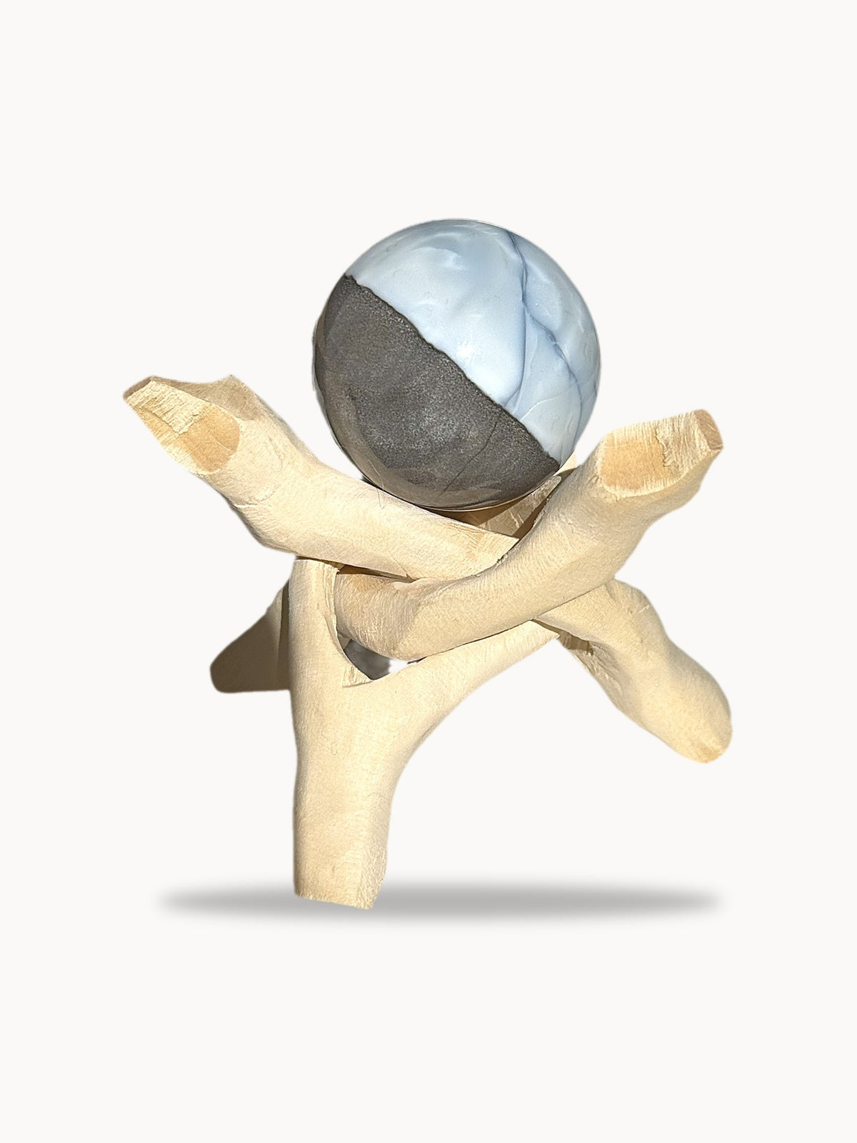 Small pale blue opal sphere on a wooden stand