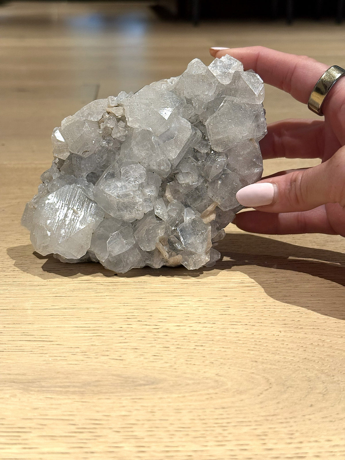 The clear apophyllite cluster held upright to show its size
