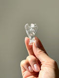 Clear quartz angel held up in the sunlight