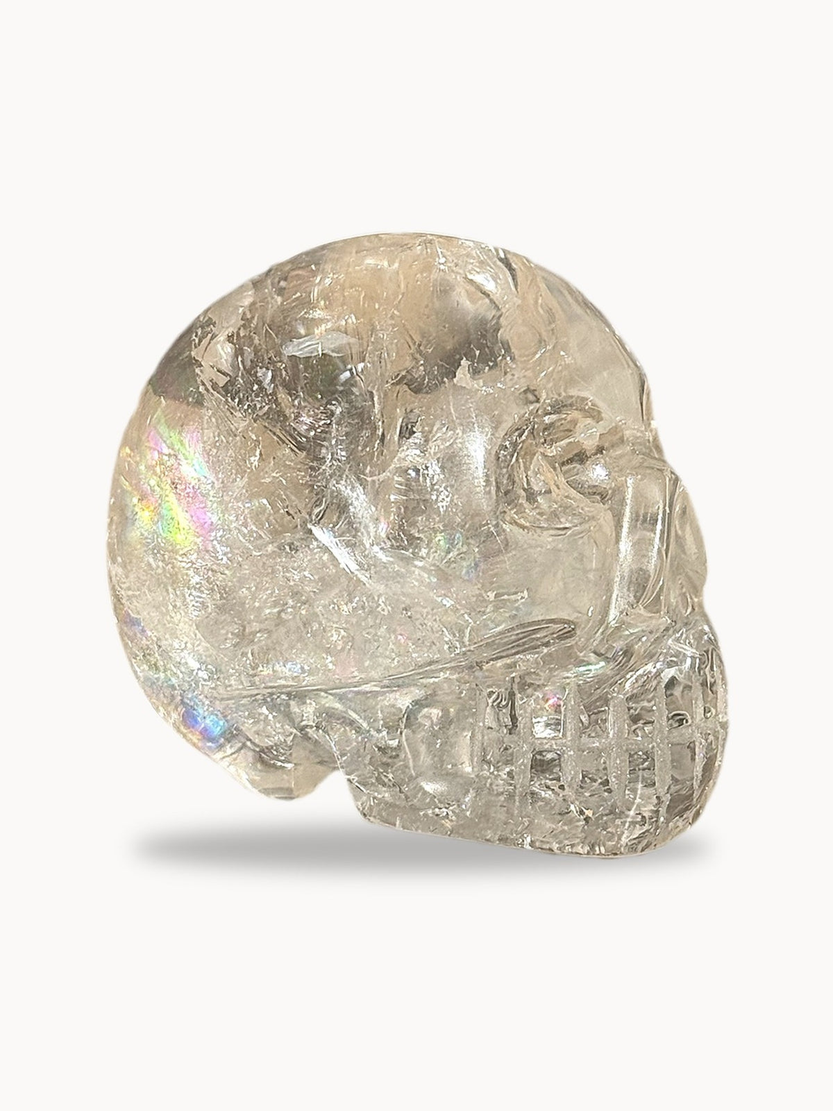 Hand-carved clear quartz skull with a rainbow inside