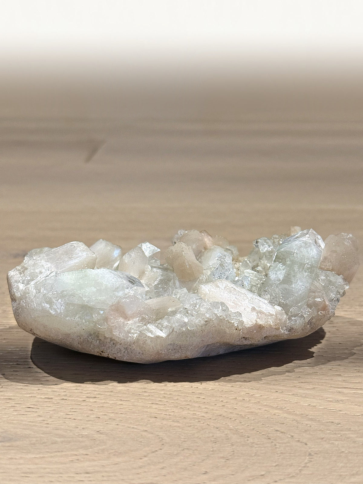 Green apophyllite and peach stilbite cluster seen from the side