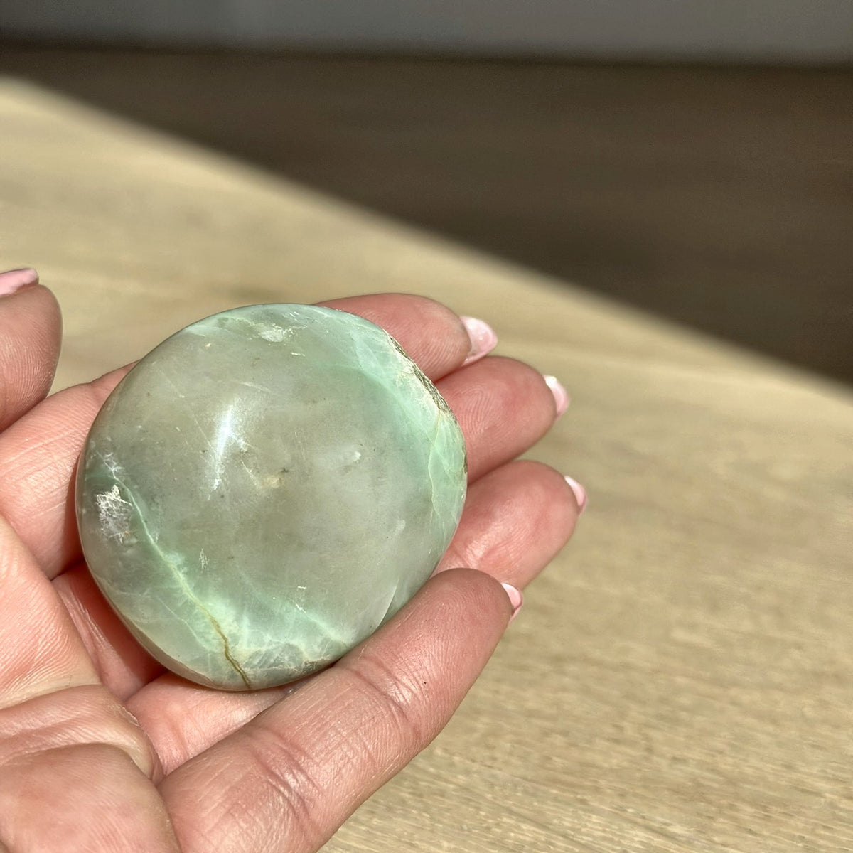 Smooth meditation stone of green moonstone, second view