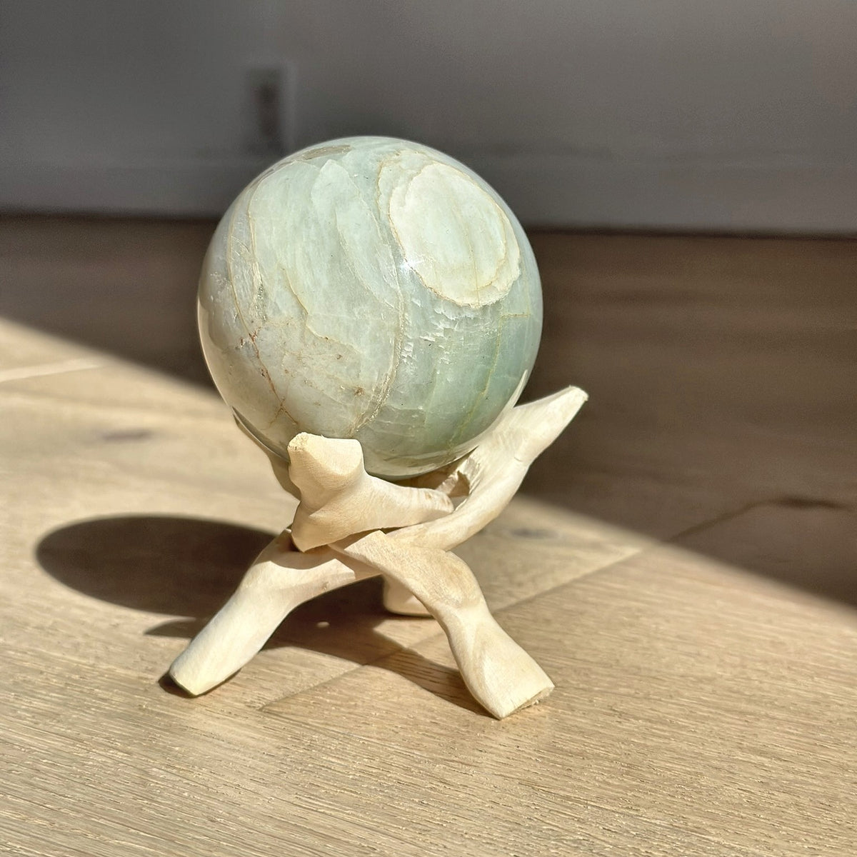 Large Green Moonstone Sphere in sunlight by Rising Star Crystals