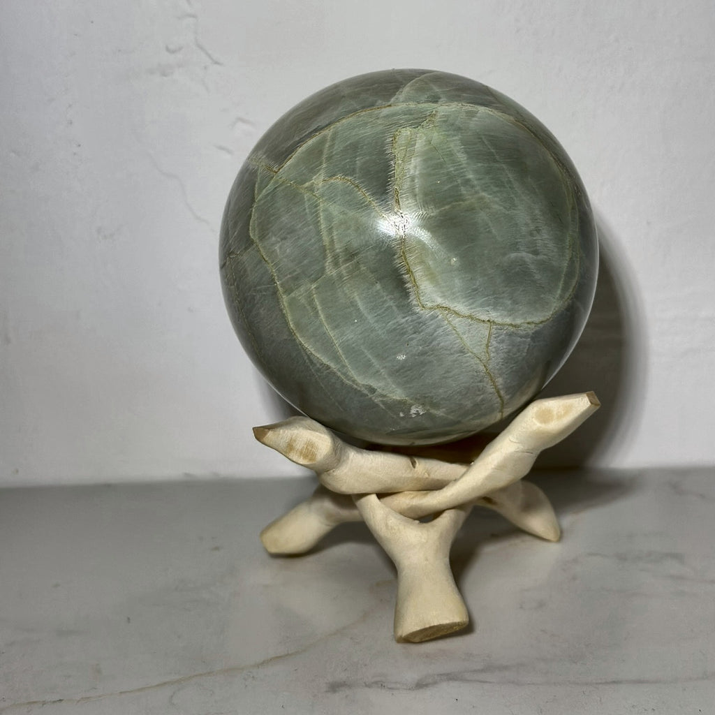 Small polished sphere of green moonstone from Madagascar