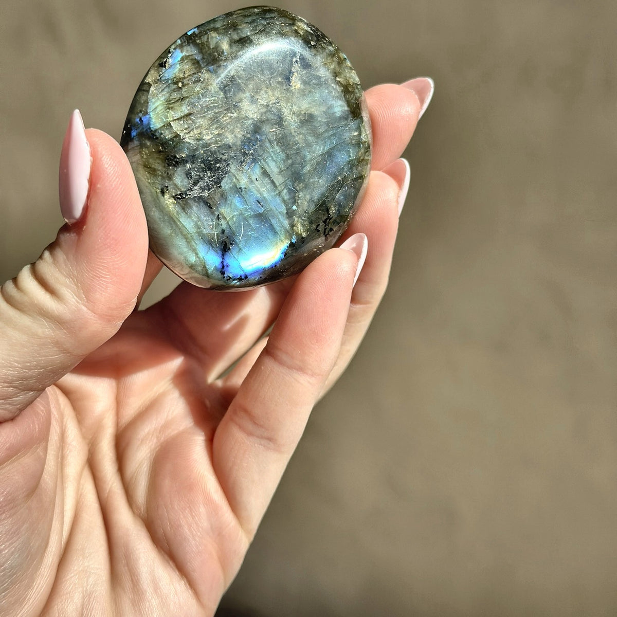 Smooth meditation stone of flashing labradorite, second view