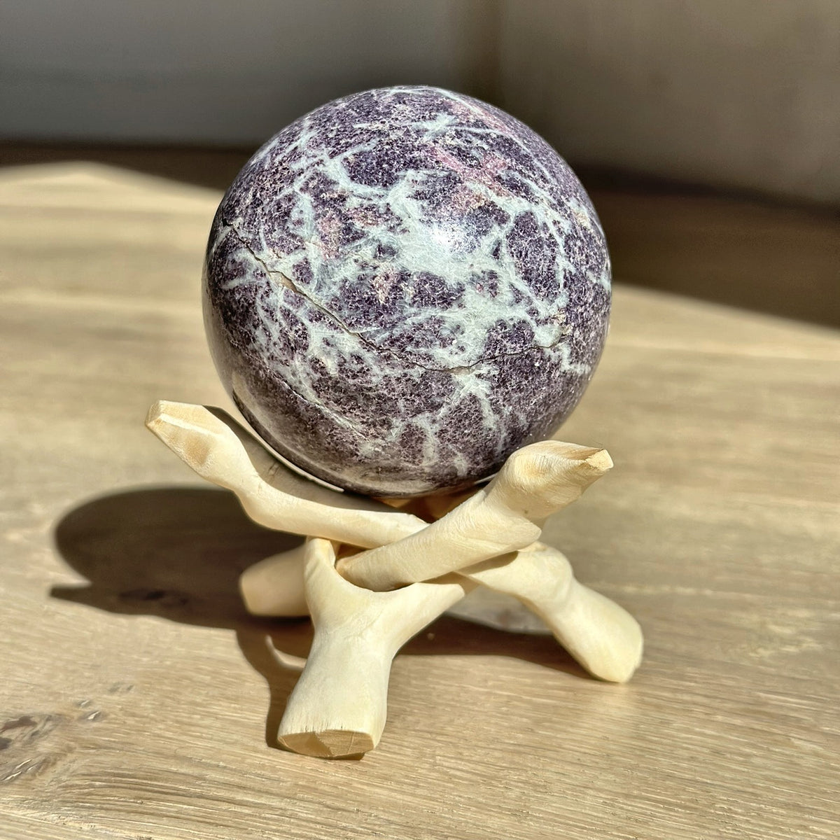 Polished sphere of lavender lepidolite