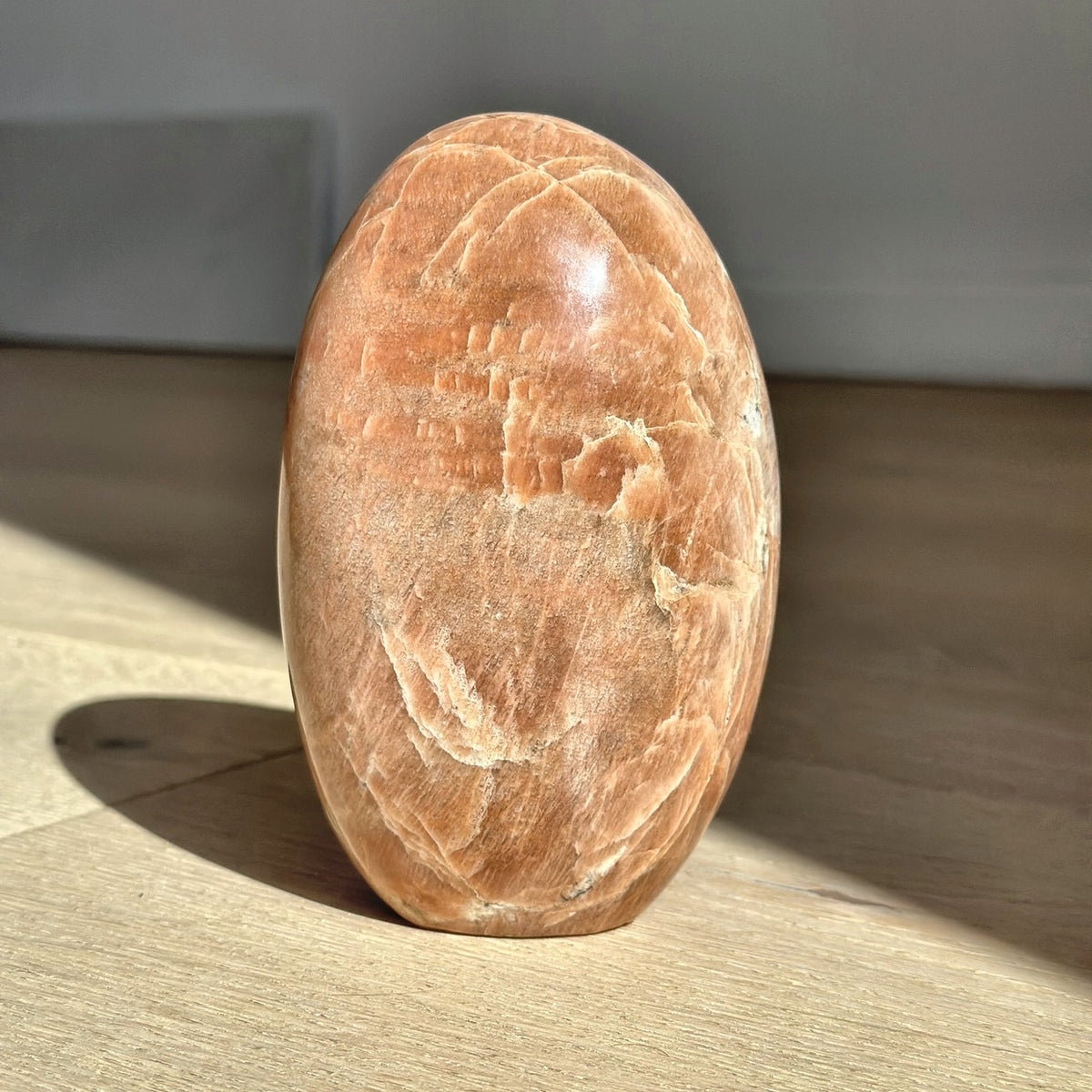 Polished dome of peach moonstone from Madagascar, second view
