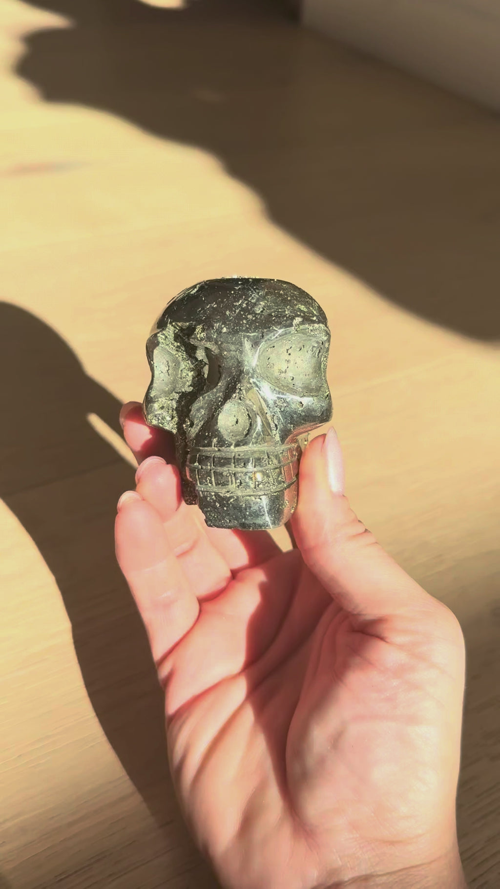 Pyrite skull No. 5 turning in the hand in sunlight