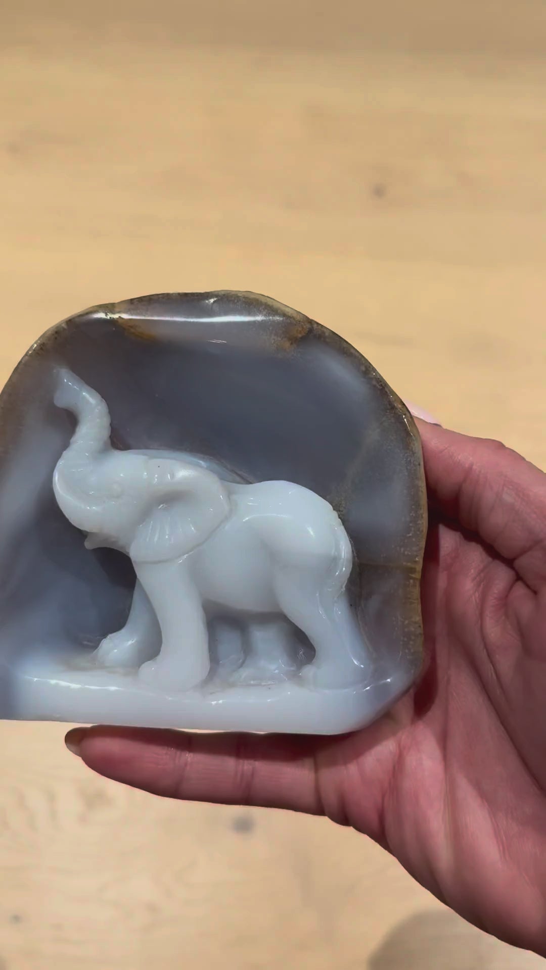 The blue chalcedony elephant carving turned in the hand
