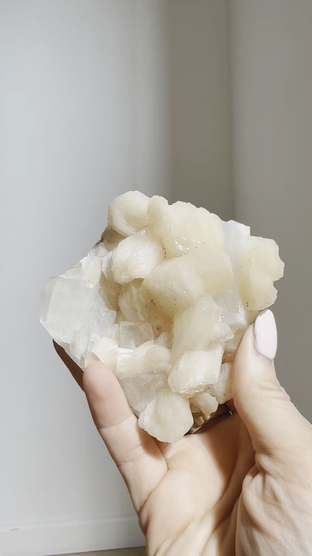 The apophyllite and peach stilbite cluster turned in the hand