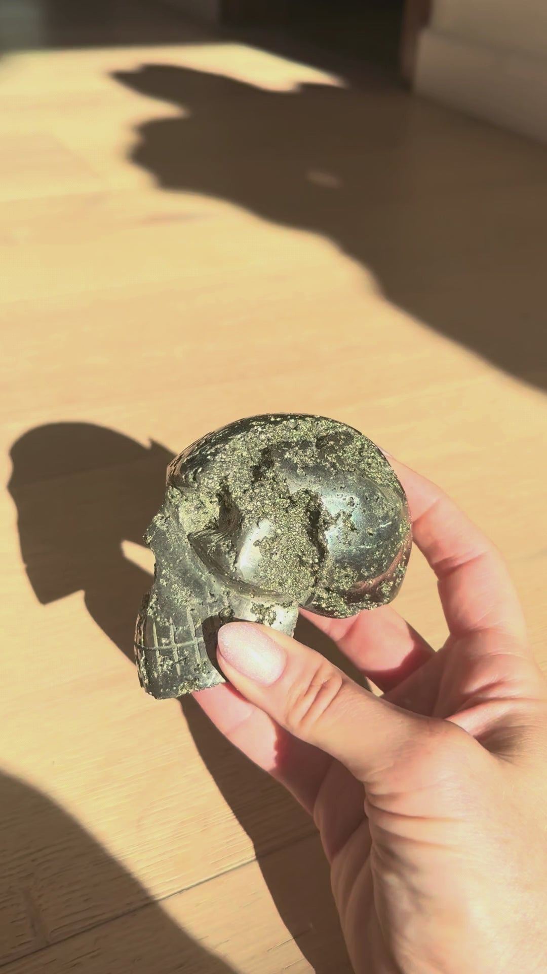 Pyrite skull No. 2 turning in the hand in sunlight