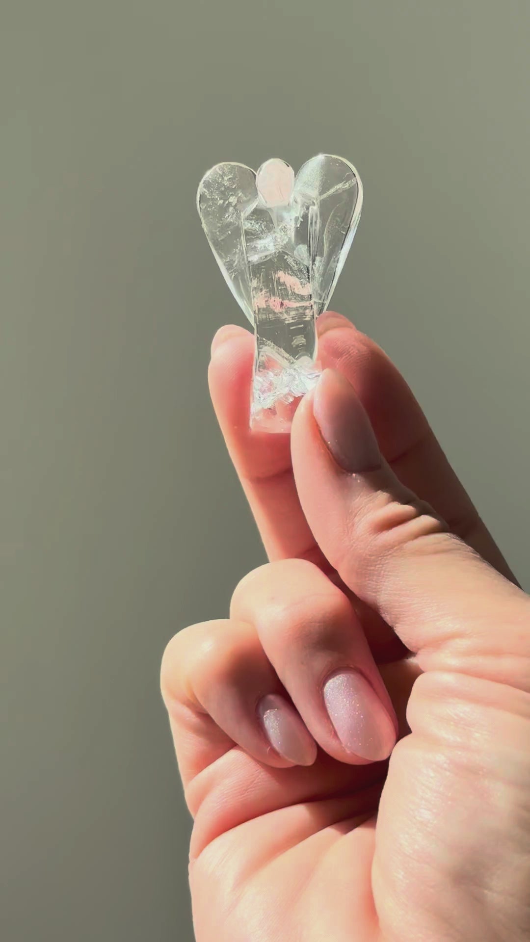 Clear quartz angel turning in the sunlight