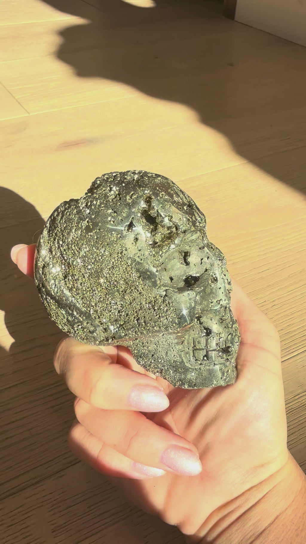 Pyrite skull No. 4 turning in the hand in sunlight