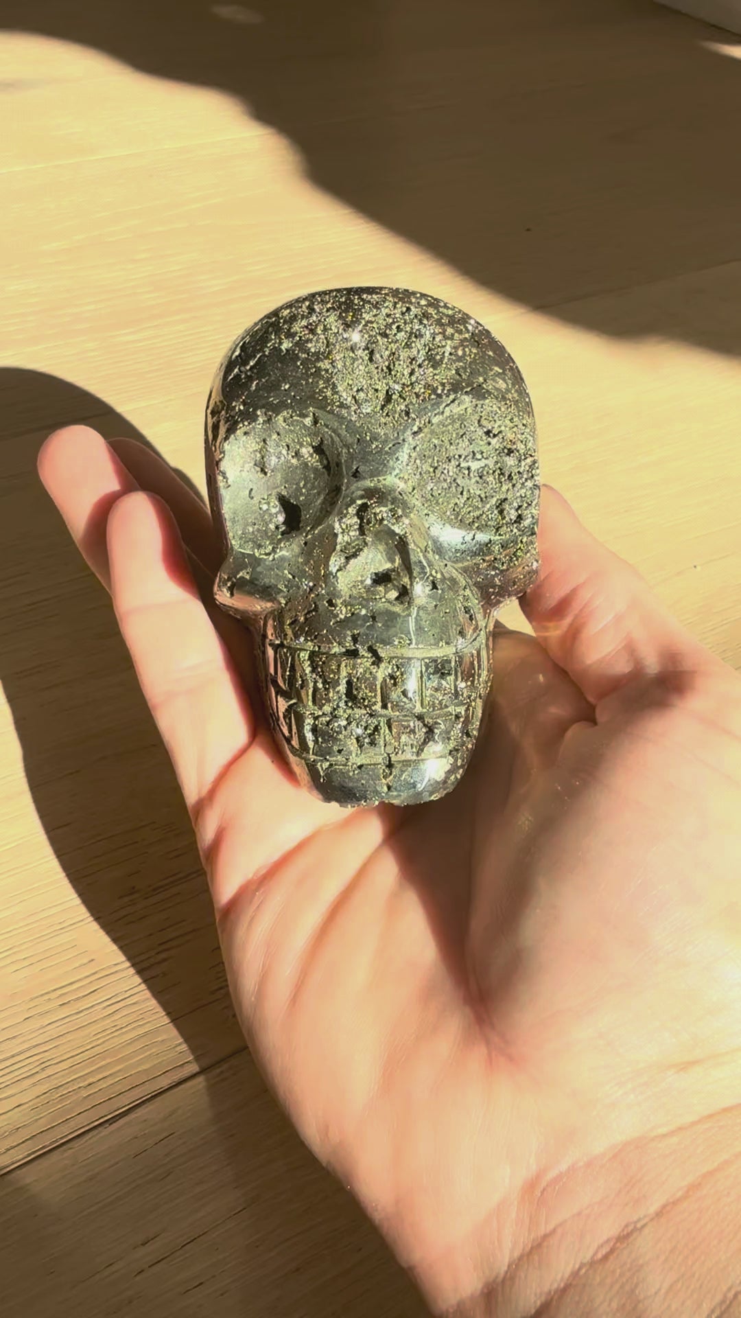 Pyrite skull No. 3 turning in the hand in sunlight