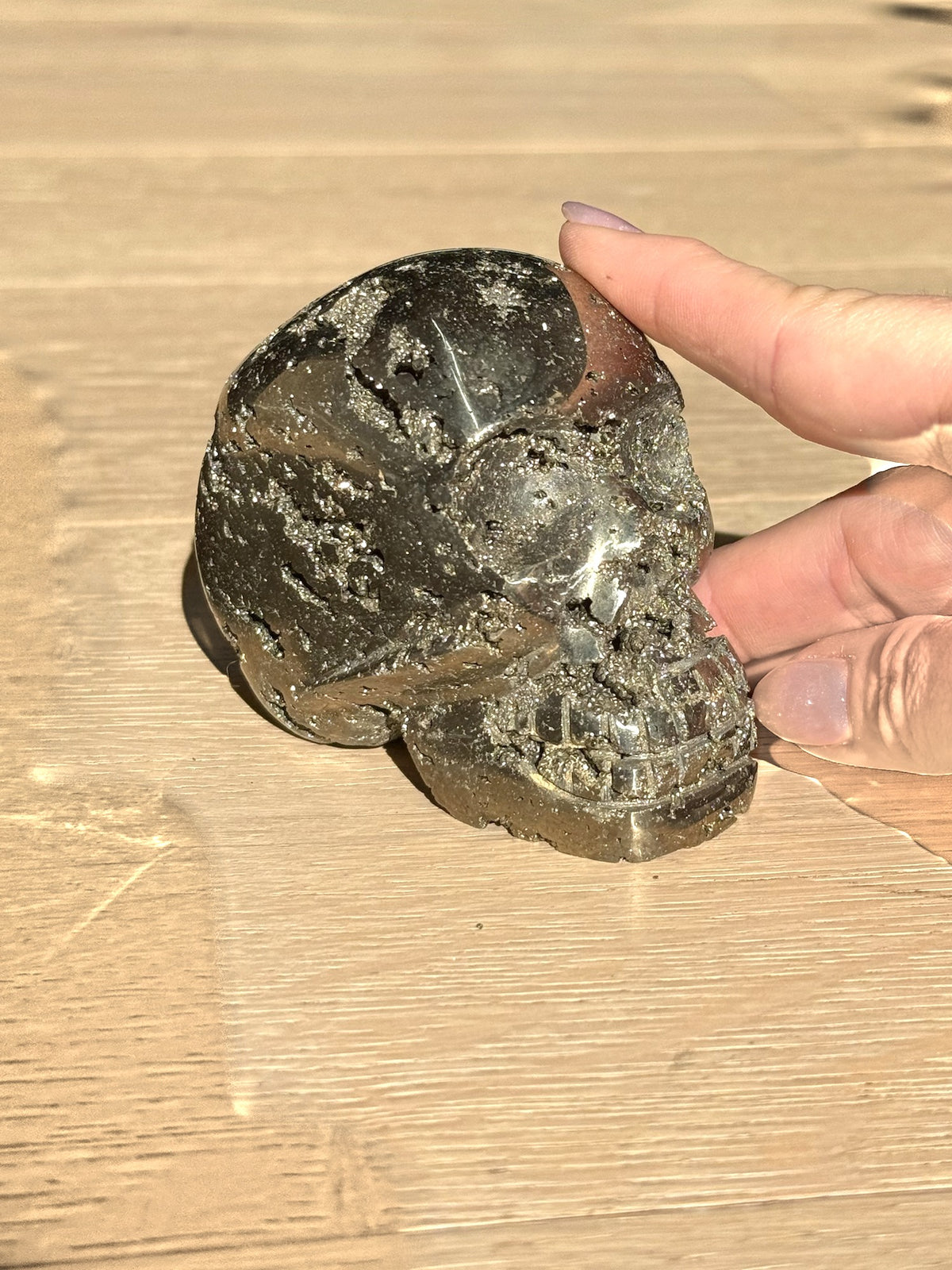 Pyrite skull No. 1 held in hand for scale