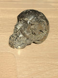 Pyrite skull No. 1, side view on a light oak floor