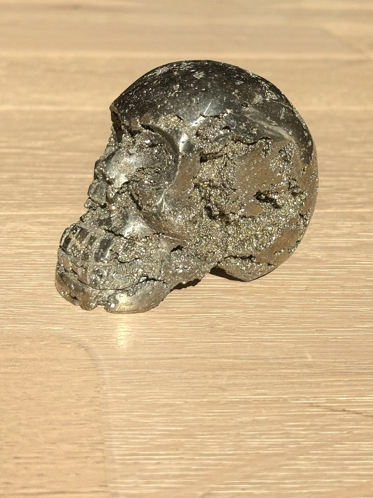 Pyrite skull No. 1, side view on a light oak floor
