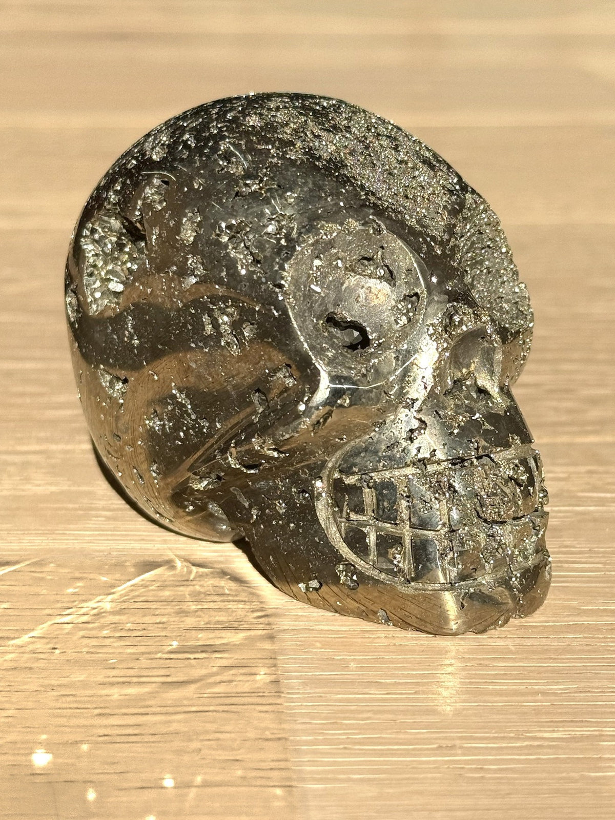 Pyrite skull No. 3, side view on a light oak floor