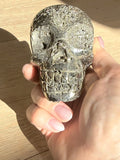 Pyrite skull No. 3 sparkling in sunlight, held in hand