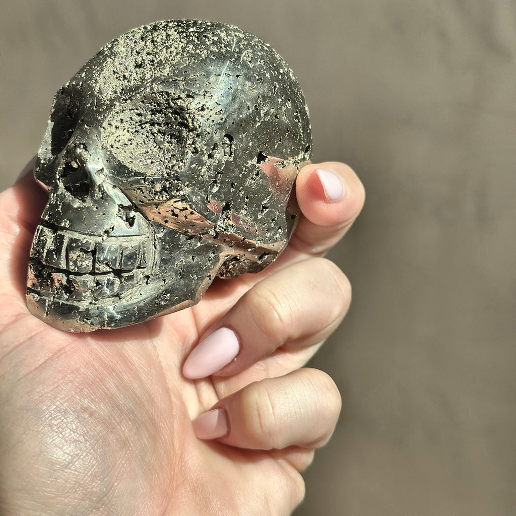 Hand-carved skull of golden pyrite from Peru, third view