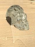 Pyrite skull No. 4 in sunlight on a light oak floor