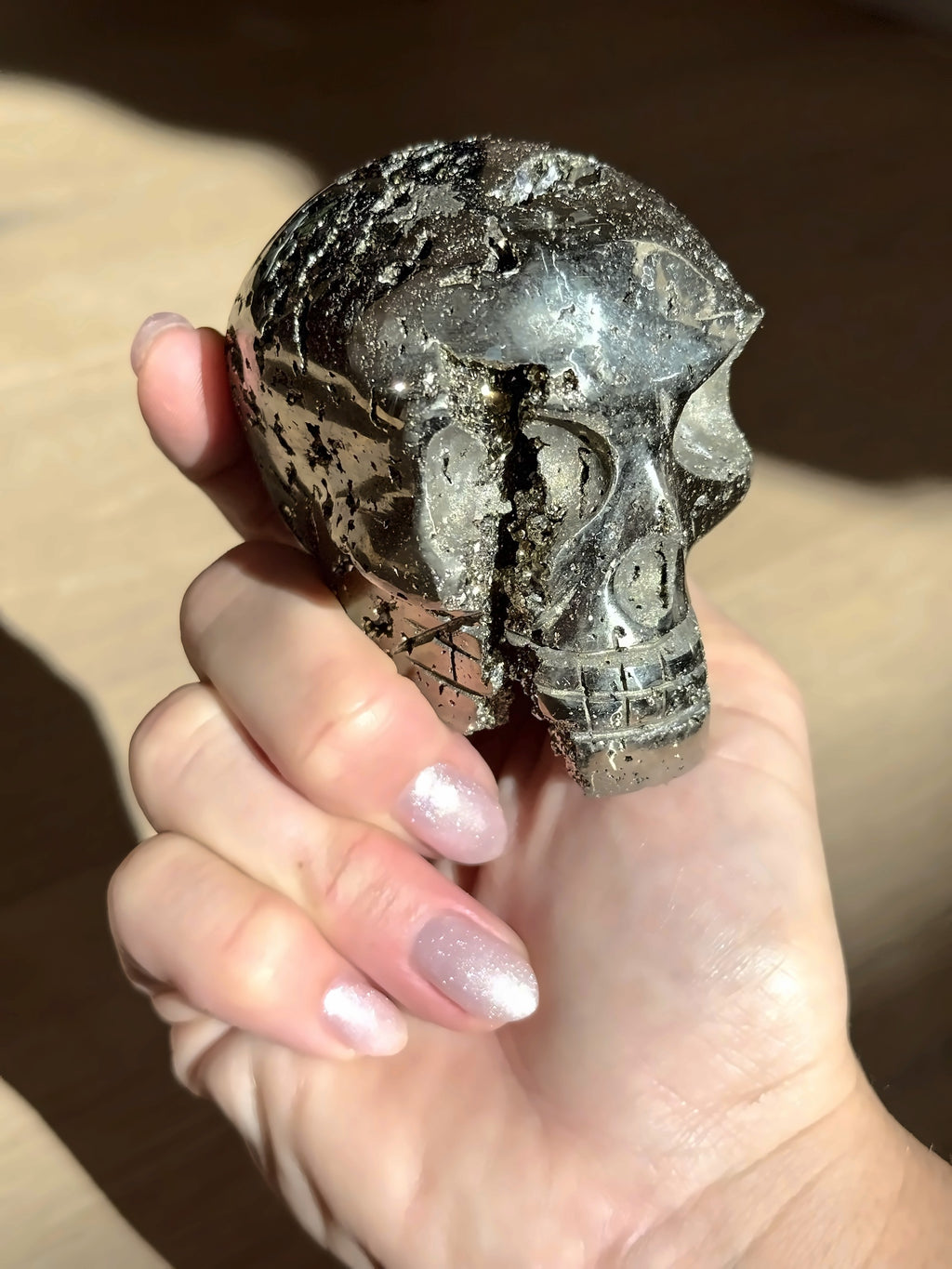 Pyrite skull No. 5 with its natural seam, held in hand