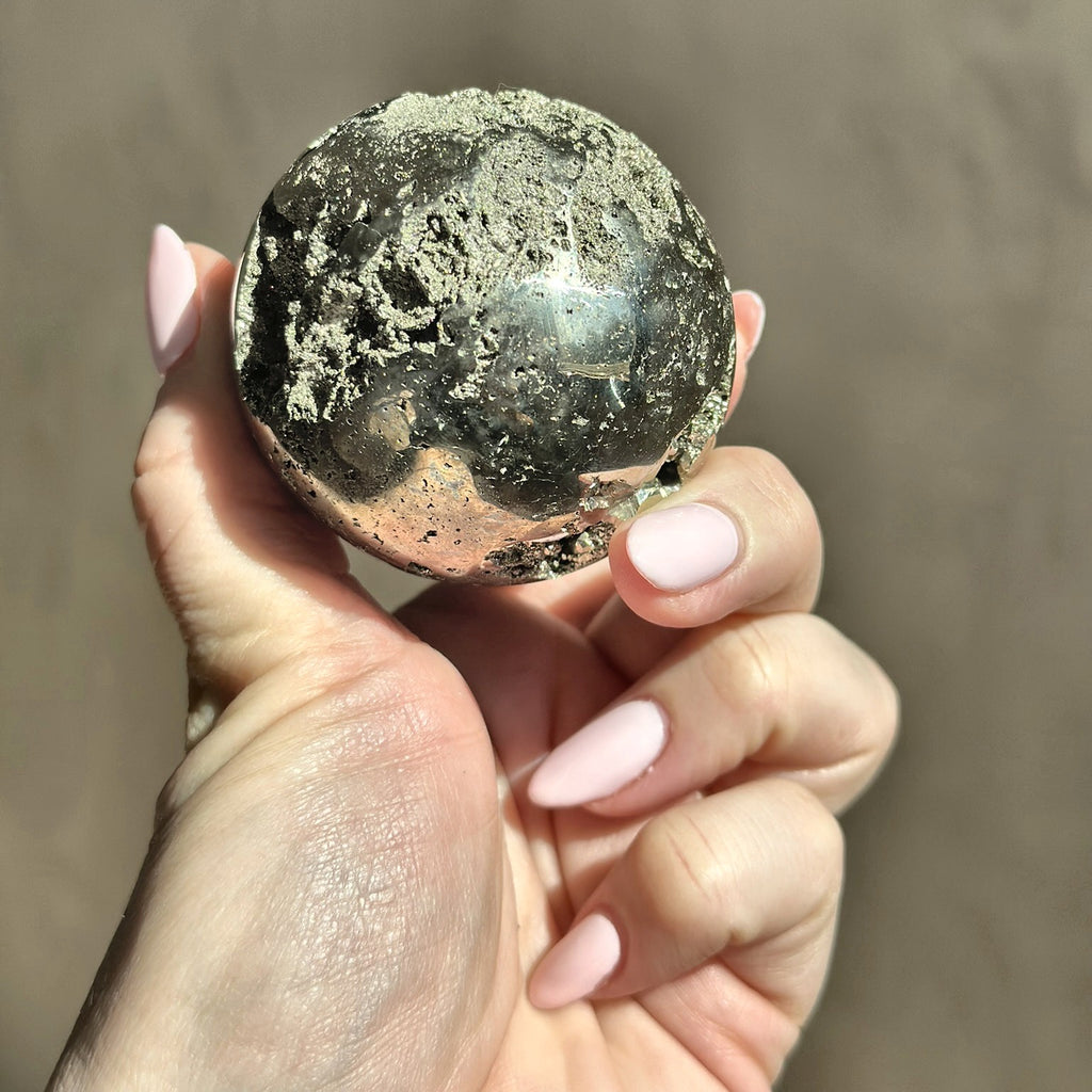 Polished sphere of golden pyrite