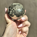 Polished sphere of golden pyrite
