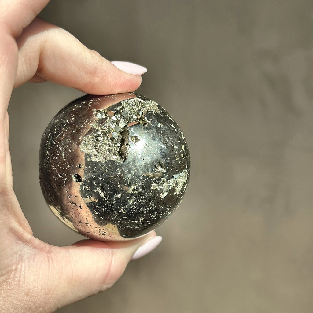 Polished sphere of golden pyrite, second view