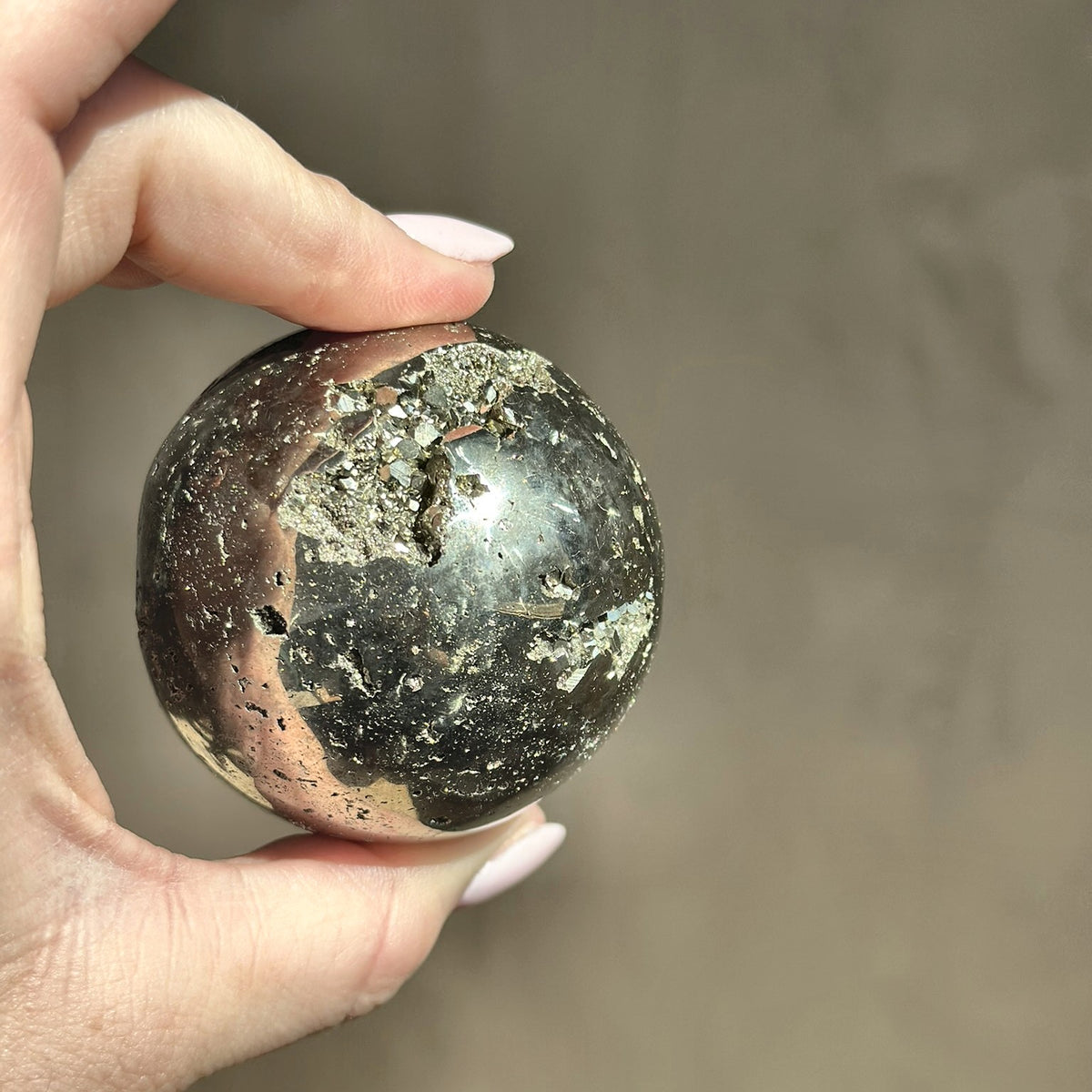 Polished sphere of golden pyrite, second view