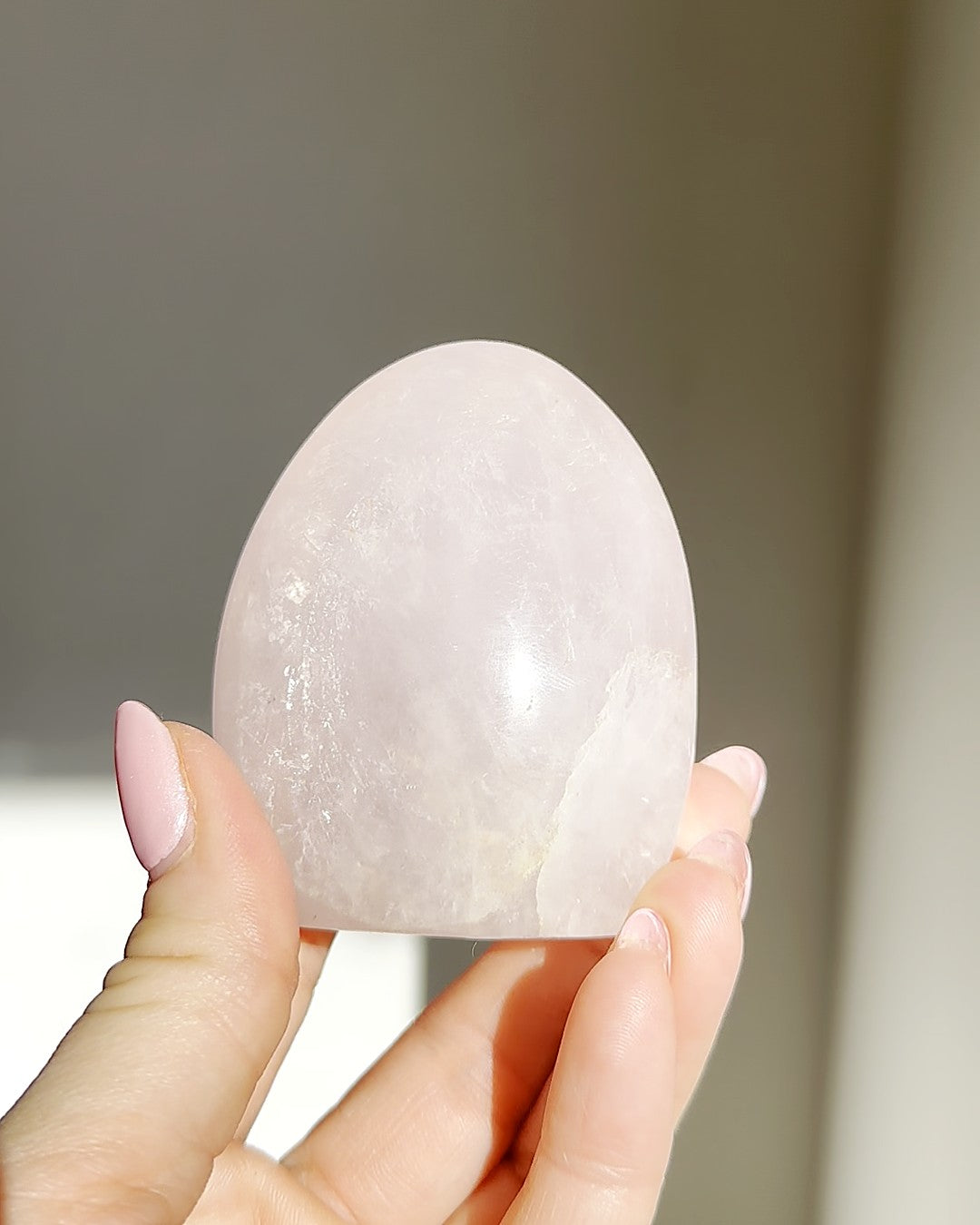 Rose quartz dome held in the sunlight, Rising Star Crystals