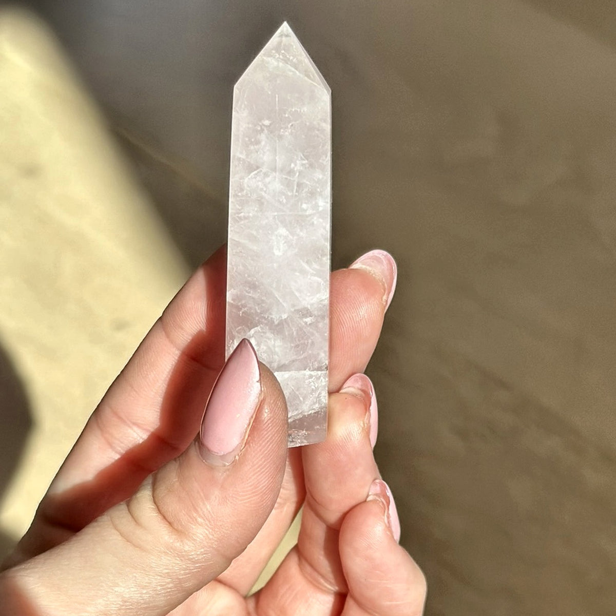 Polished point of soft pink rose quartz