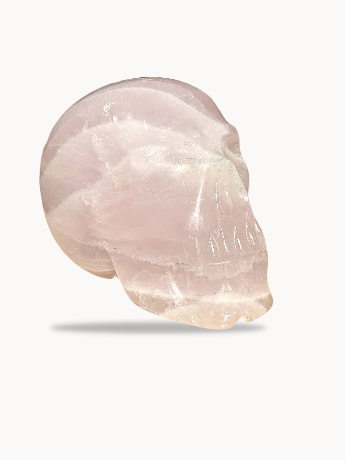 Large hand-carved rose quartz skull, three-quarter view