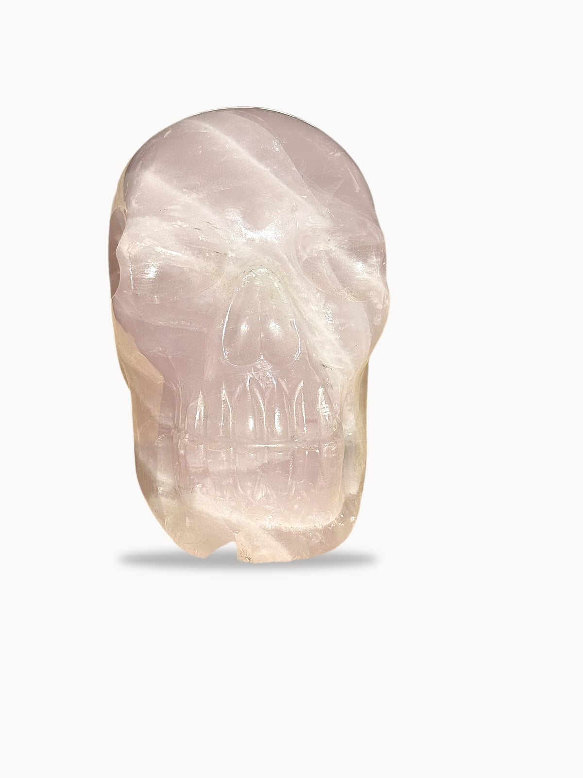 Large rose quartz skull, front view with white banding