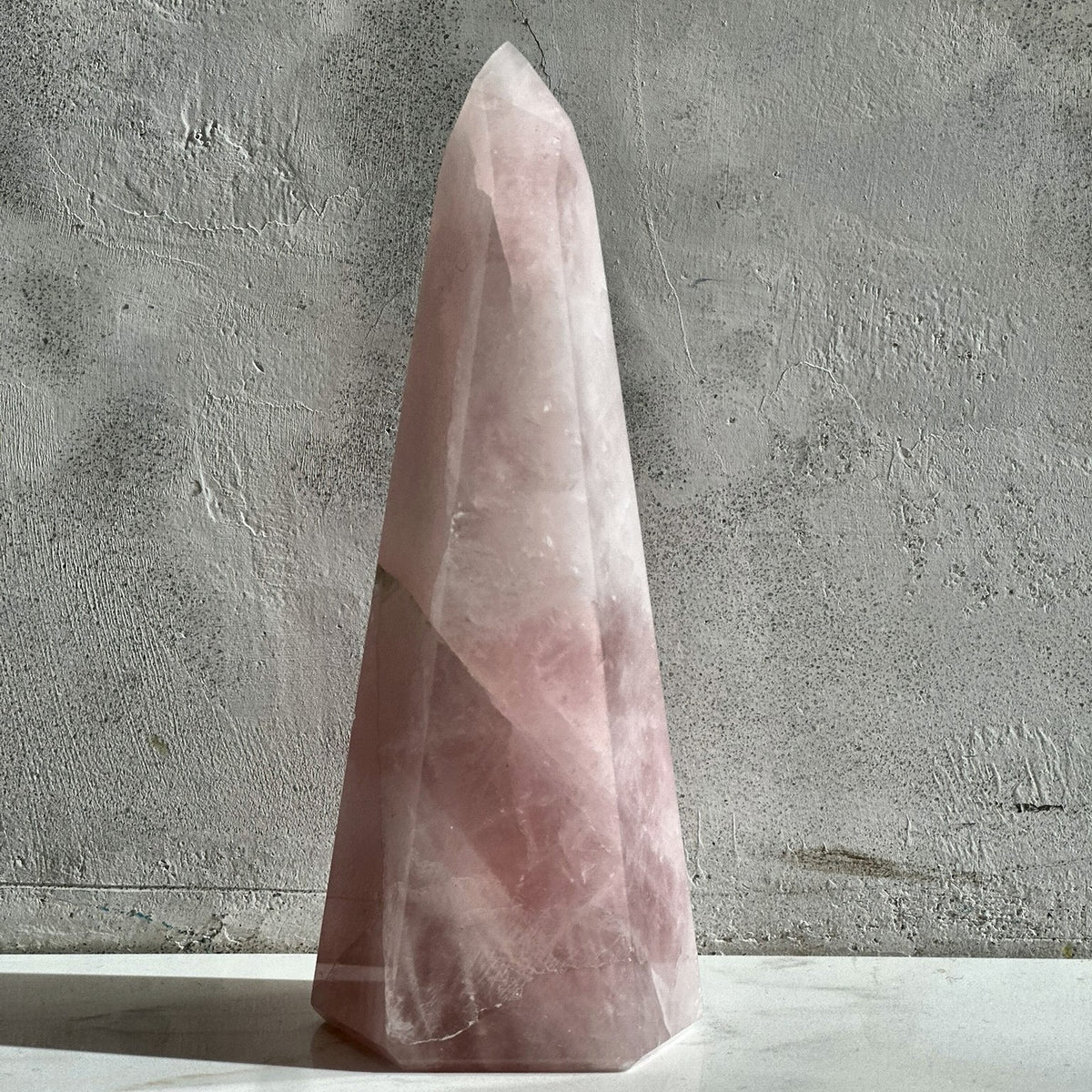 Polished tower of soft pink rose quartz from Madagascar
