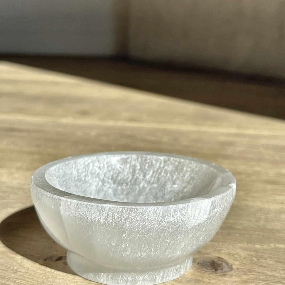 Carved bowl of pearly white selenite, third view