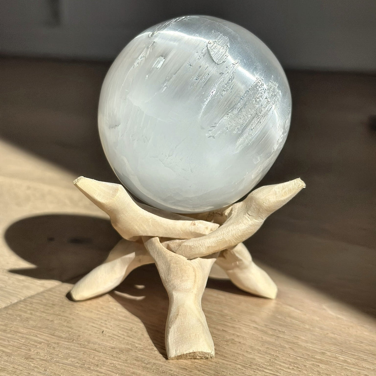 Large polished sphere of pearly white selenite